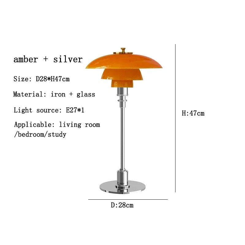 Table lamp with amber shade and silver base on a white background