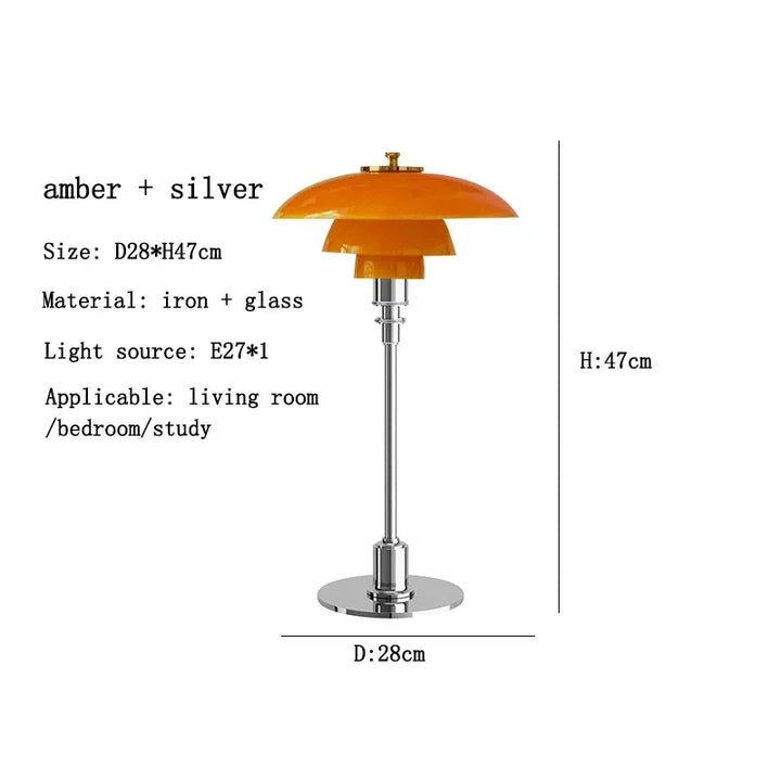 Table lamp with amber shade and silver base on a white background