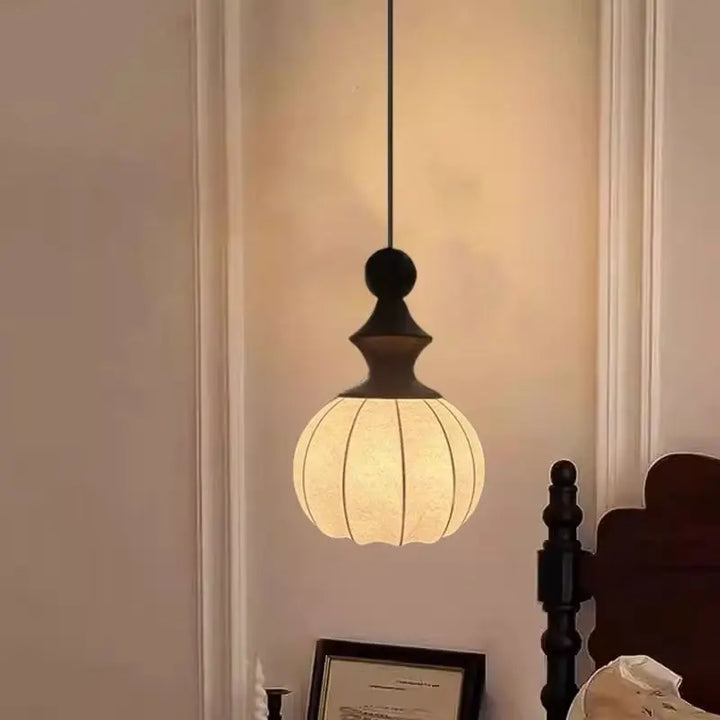 Wooden pendant hanging in a room with a blurred background