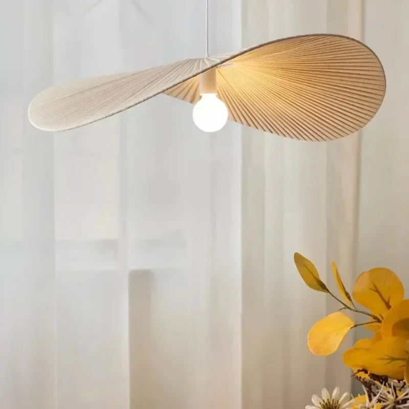 Wooden pendant light with a white bulb against a neutral background