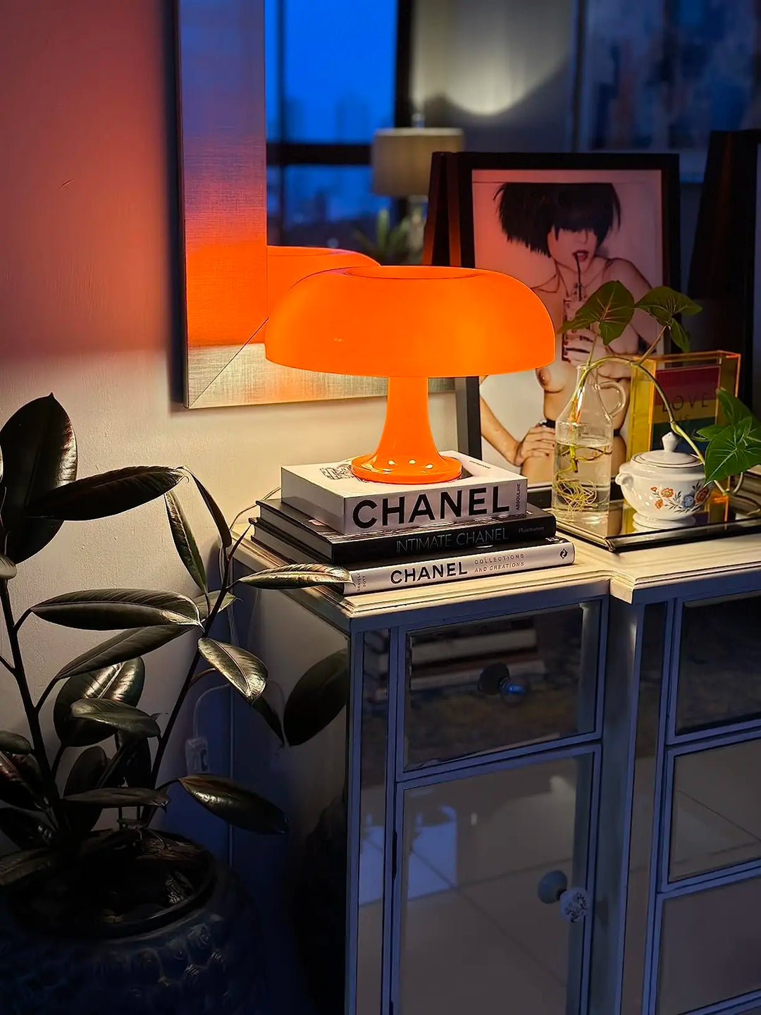 Orange lamp on Chanel books with a blurred background