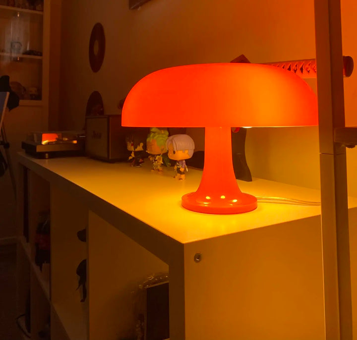 Orange table lamp on a desk with a warm glow