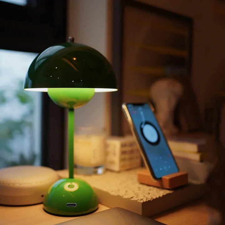 Green lamp on a wooden surface with a blurred background