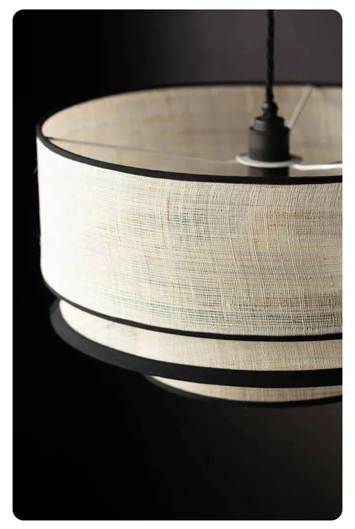 Close-up of a lampshade with black and white design on a dark background