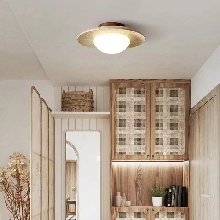 Ceiling light fixture in a room with wooden cabinets and decor