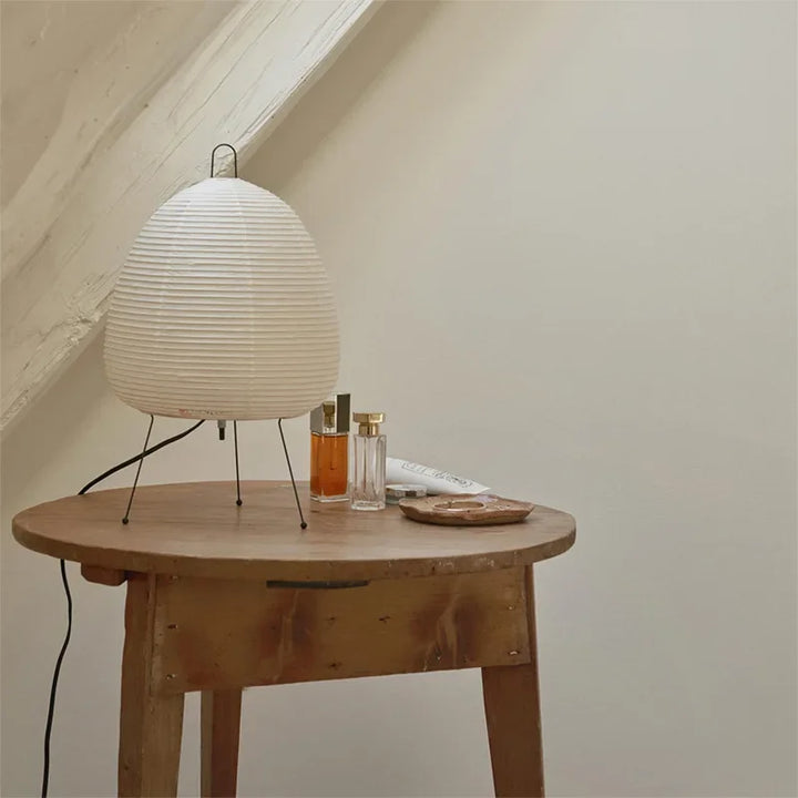 White textured lamp on a wooden table with a neutral background
