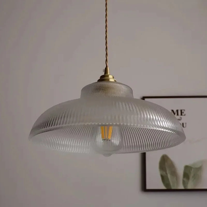 Vintage-style pendant light with ribbed glass shade on a neutral background