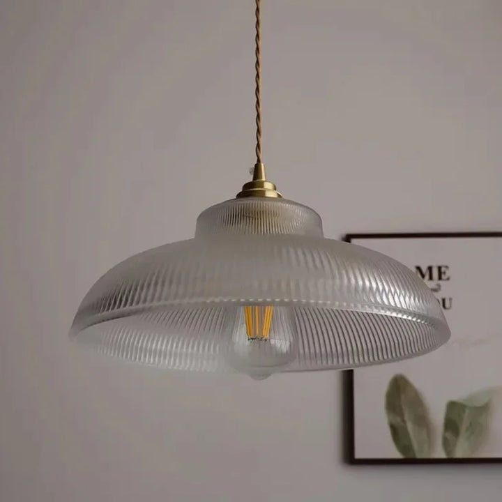 Vintage-style pendant light with ribbed glass shade on a neutral background